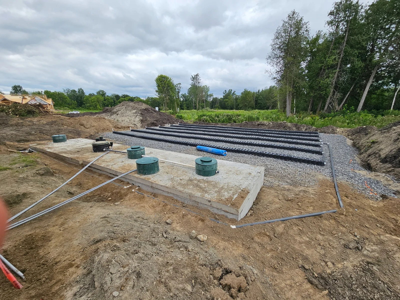 Concrete septic tanks and distribution chambers installed on a stone bed